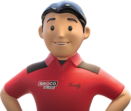 Brody, the BrocoGlass mascot, a figurine-like man wearing a red polo and smiling